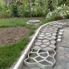 a stone walkway in the middle of a garden