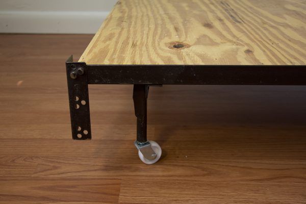 a wooden table with two wheels on it