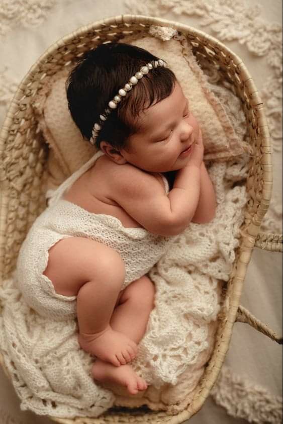 a baby is sleeping in a basket