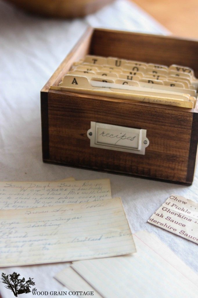 a wooden box sitting on top of a table next to some old letters and envelopes