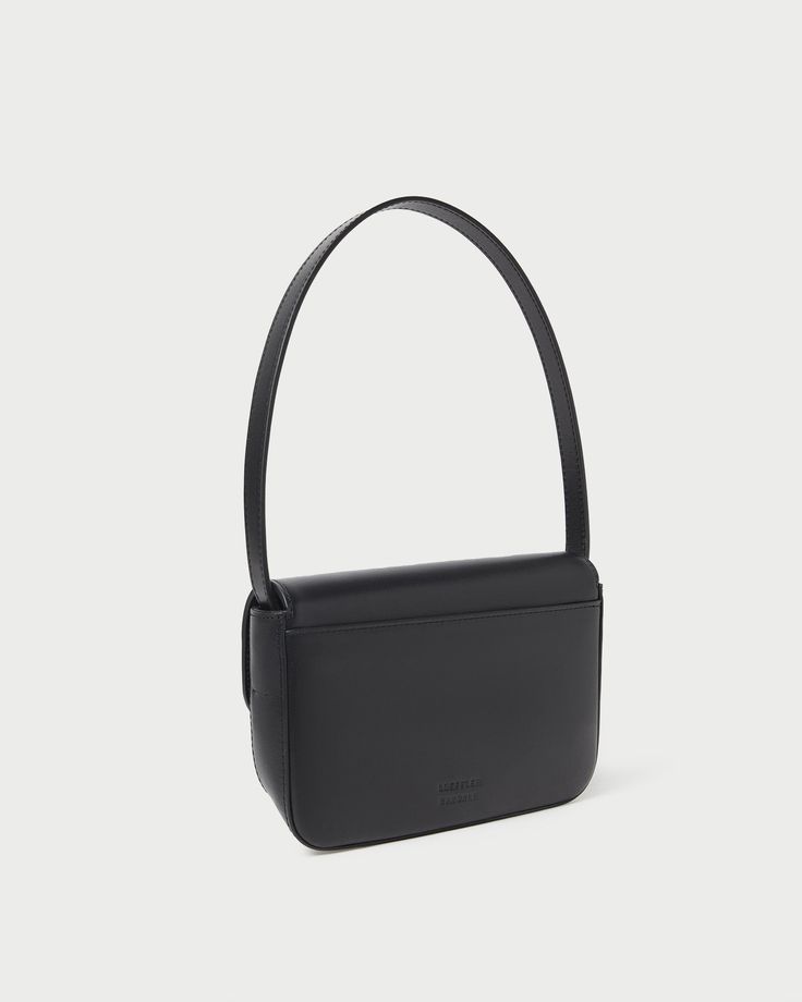 Shoulder baguette bag in black vachetta leather. Features slim tonal handles, a push lock closure, full lining, interior zippered pocket, and exterior slip pocket. Classic Baguette Bag With Detachable Handle, Classic Baguette Satchel Bag With Detachable Strap, Classic Satchel Baguette Bag With Detachable Strap, Classic Baguette Bag With Removable Pouch, Classic Baguette Bag With Top Handle And Removable Pouch, Classic Satchel Baguette Bag For Business, Classic Shoulder Baguette Bag, Classic Baguette Shoulder Bag, Classic Baguette Satchel Bag With Detachable Handle