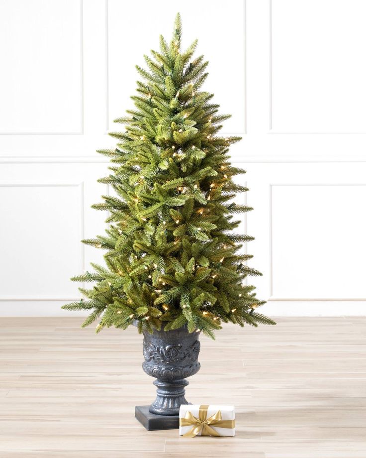 Create a welcoming ambience for your entryways or living room with an exceptionally lifelike potted Christmas tree. The Highland Estate Potted Spruce comes in an elegantly carved designer pot and features fresh-green tipped needles and light brown stems for added depth and realism. Porch Topiary, Christmas Tree Topiary, Potted Christmas Tree, Outdoor Topiary, Realistic Artificial Christmas Trees, Potted Christmas Trees, Spruce Christmas Tree, Topiary Plants, Artificial Topiary