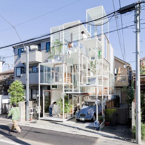 an apartment building with multiple floors and balconies on the top floor is surrounded by greenery