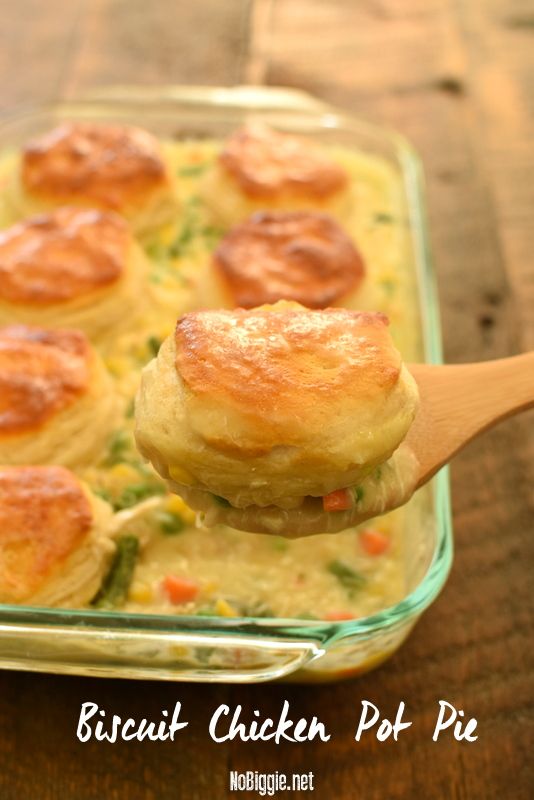 broccoli chicken pot pie is being lifted from a casserole dish with a wooden spoon