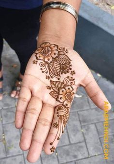 a woman's hand with henna on it