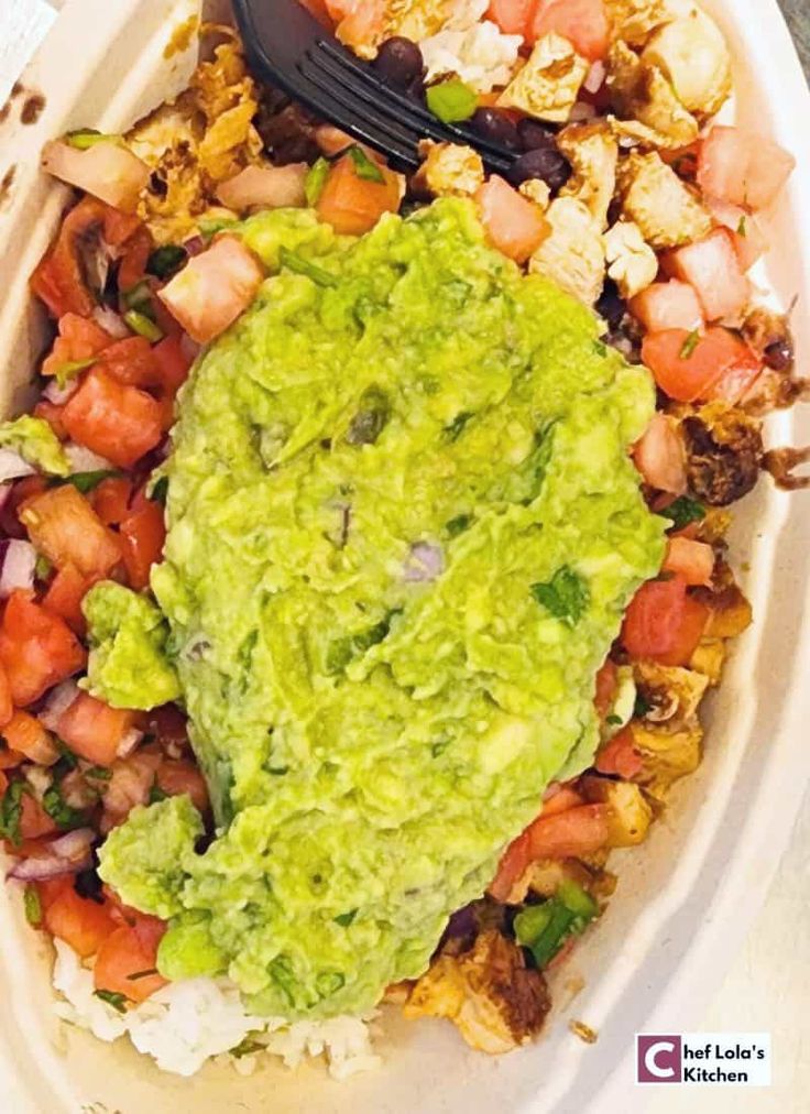 a white plate topped with guacamole and shrimp