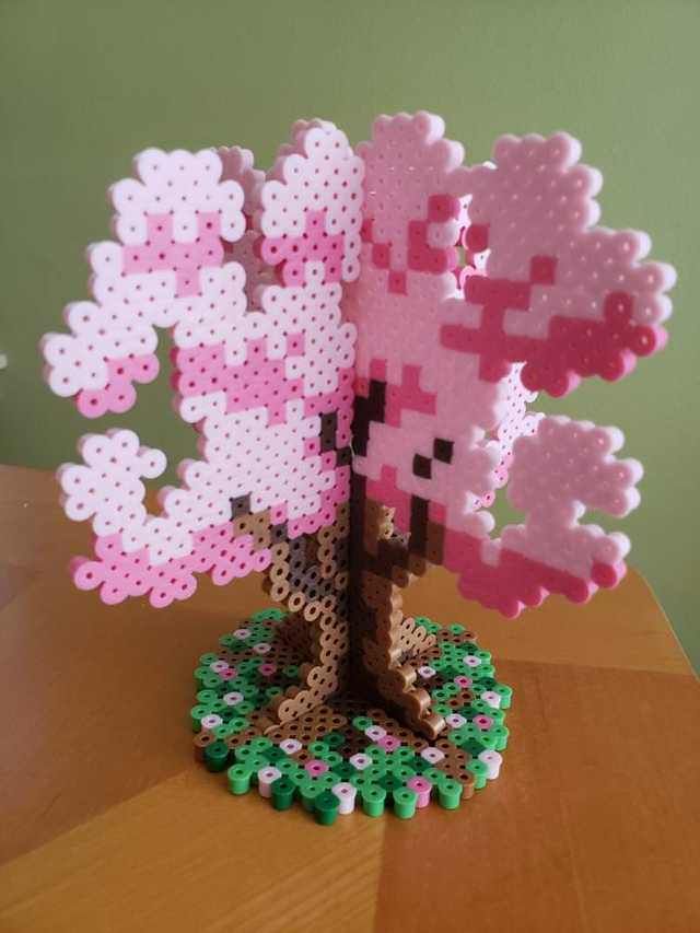 a pink and white tree made out of perler beads