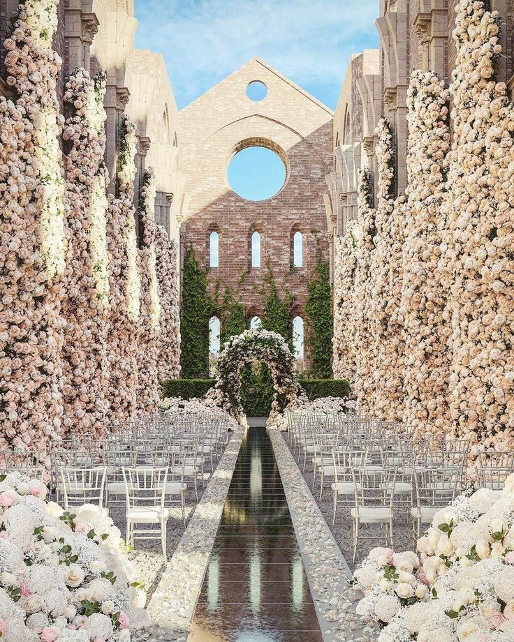 an artist's rendering of the inside of a church with rows of chairs and flowers