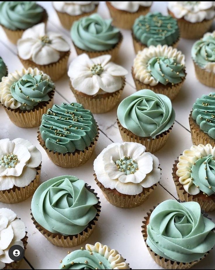 cupcakes with green frosting and white flowers