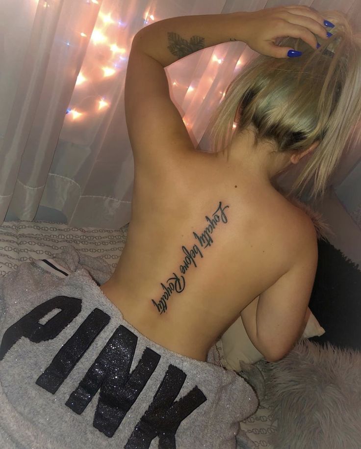 a woman with a tattoo on her back