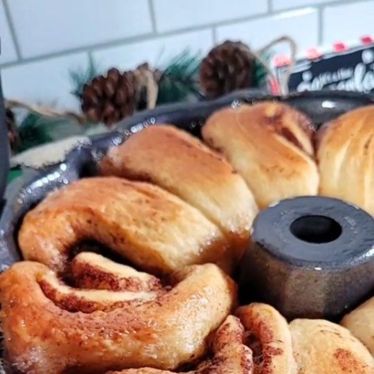 a pan filled with cinnamon rolls on top of a counter