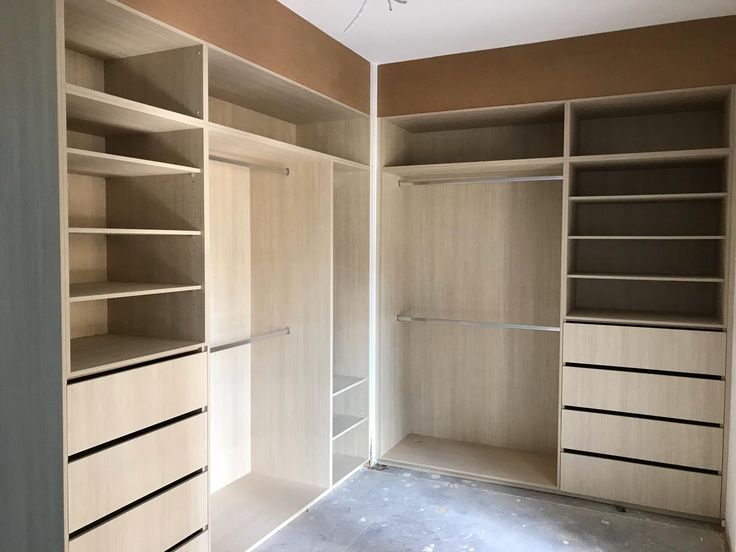 an empty walk in closet with shelves and drawers