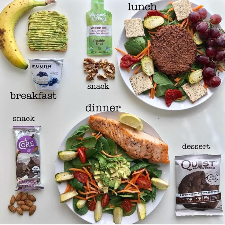 a white table topped with plates of food and veggies next to each other