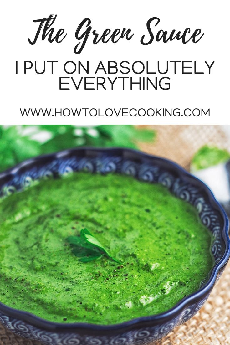 a bowl filled with green sauce on top of a table