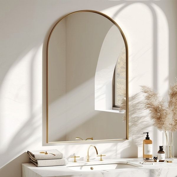 a bathroom with a sink, mirror and toiletries