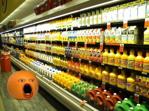 a store filled with lots of orange juices and bottles next to an angry face