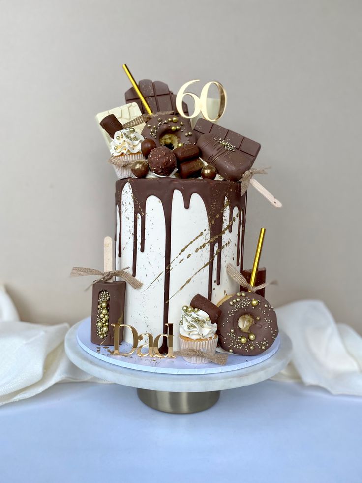 there is a cake that has chocolate on the top and gold decorations on the bottom