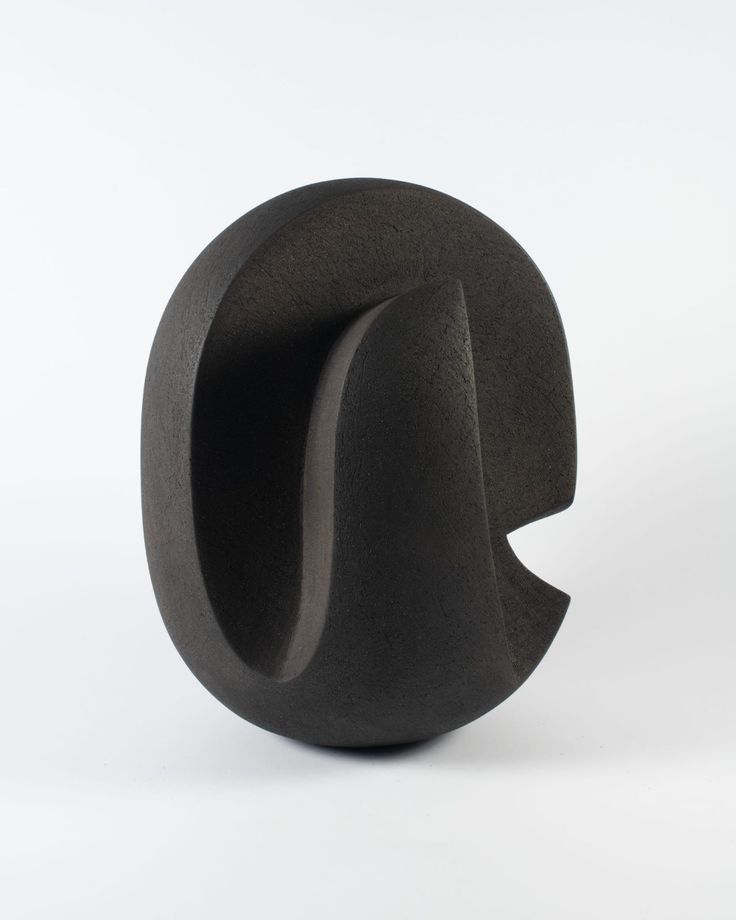 a black sculpture sitting on top of a white surface