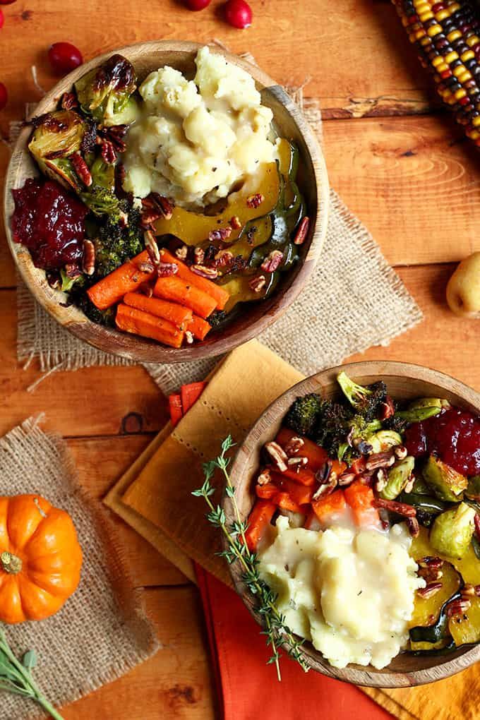 two bowls filled with mashed potatoes and vegetables