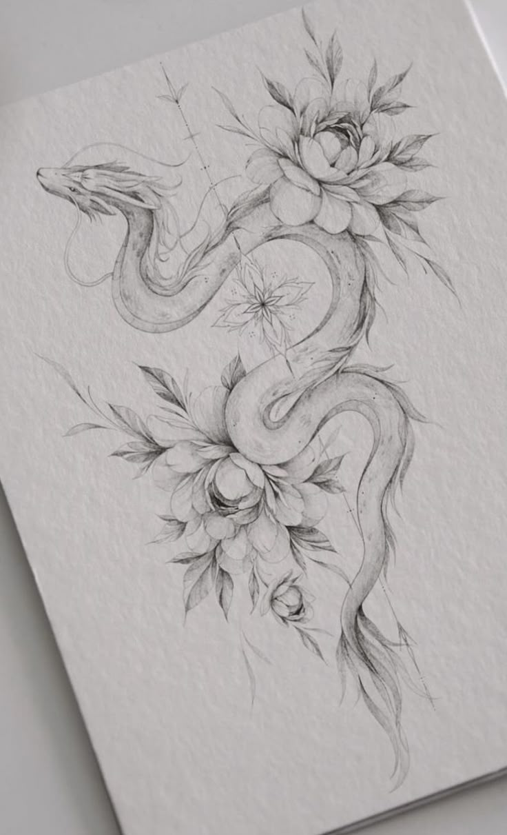 a drawing of a snake and flowers on paper