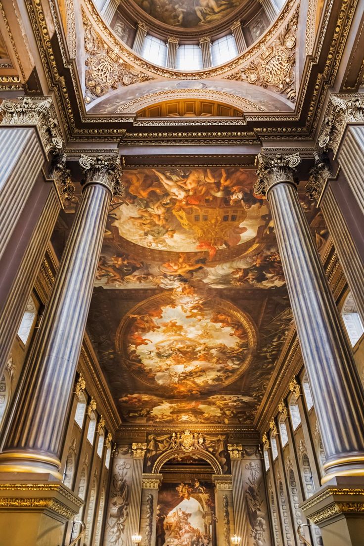 the interior of a church with paintings on the ceiling and columns in front of it