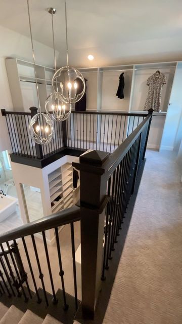 a staircase with chandelier and light fixtures