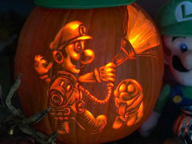 a pumpkin carved to look like mario and luigi