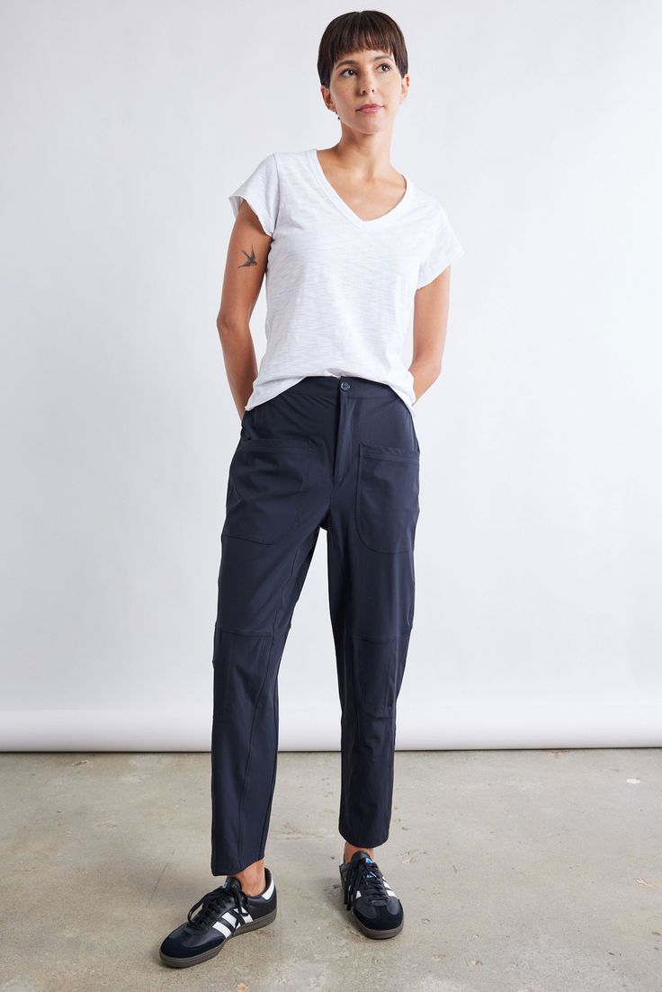 These pants combine airy comfort with a modern silhouette, offering a versatile staple for all-year-round. With their tailored fit and breathable fabric, these pants effortlessly blend sophistication with laid-back charm, making them the perfect go-to piece. Tailored fit and tapered leg Elasticized waist with hook-and-bar closure Relaxed leg Belt loops 2 side pockets Vertical seams Leg Belt, Charm Making, Slim Pants, Black Pants, Breathable Fabric, Latest Fashion, Fashion Forward, Bar, Pants