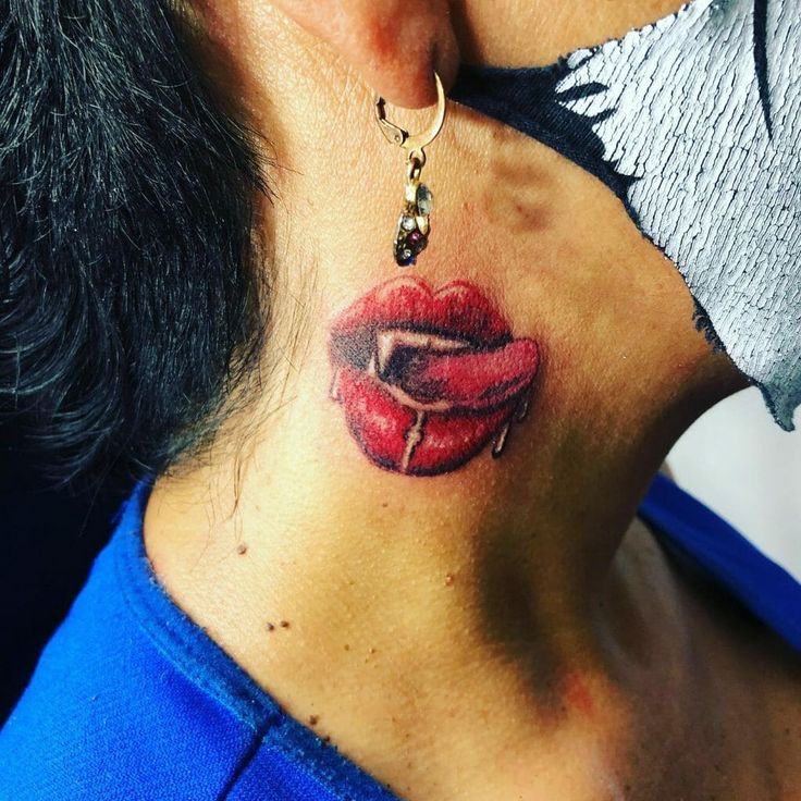 a woman with a red lip tattoo on her neck