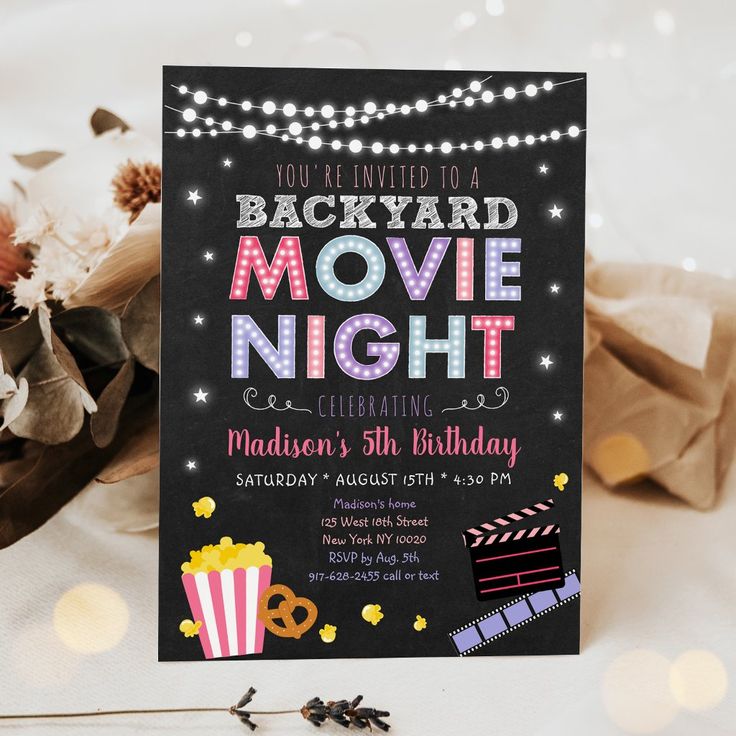 this is an image of a movie night birthday party with popcorn, cake and lights