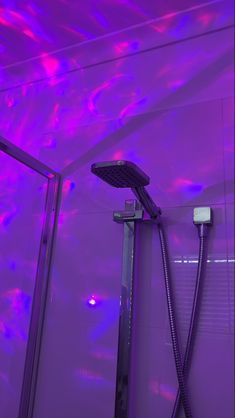 a shower with purple lighting in a bathroom