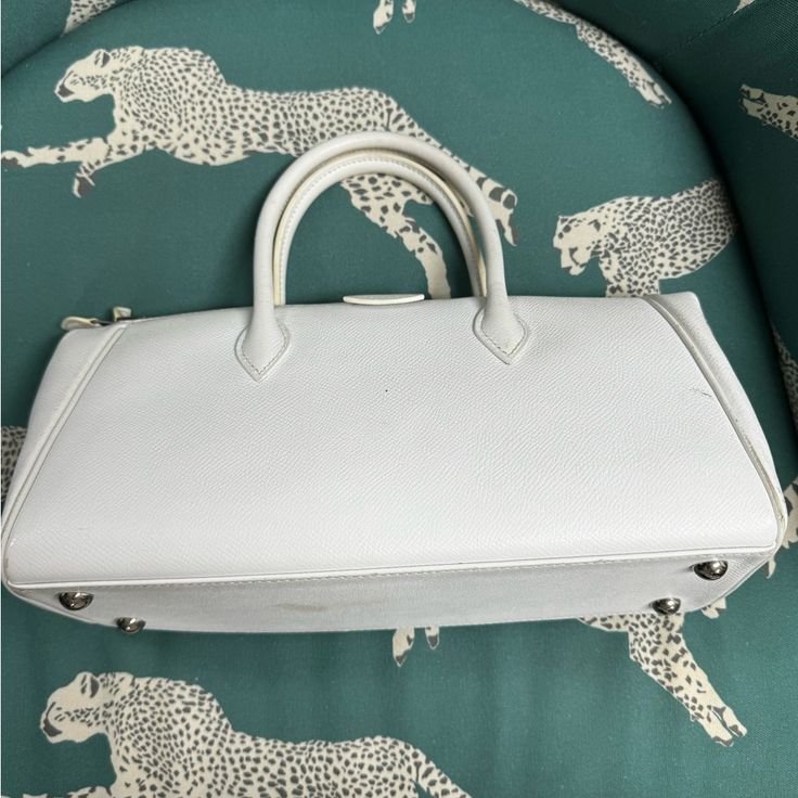 Hermes Handbag In Good Condition. Preloved. Comes With Entrupy Certificate Of Authenticity. White Satchel With Silver-tone Hardware For Formal Occasions, White Formal Satchel With Silver-tone Hardware, Elegant White Handheld Satchel, Luxury White Satchel With Silver-tone Hardware, White Bags With Silver-tone Hardware For Formal Occasions, Luxury White Satchel For Travel, Formal White Bags With Silver-tone Hardware, White Designer Satchel For Formal Occasions, Elegant White Satchel With Silver-tone Hardware