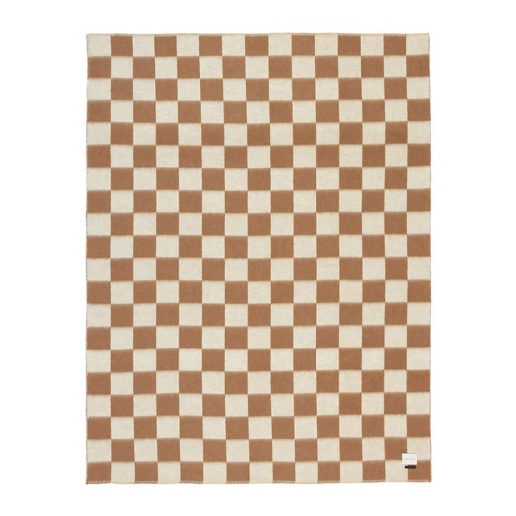 a brown and white checkered rug on a white background