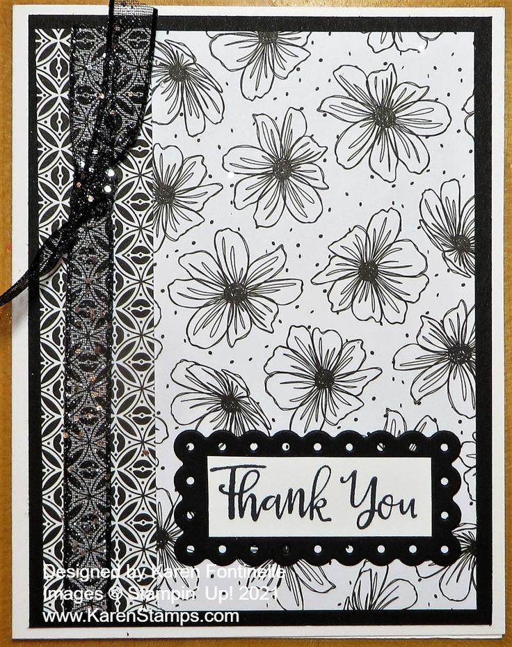 a thank card with black and white paper flowers on it, the words thank you are written