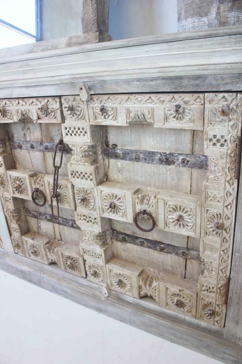 an old wooden cabinet with decorative carvings on it