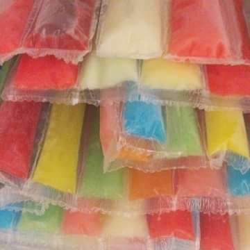 many different colored pieces of cake in plastic bags