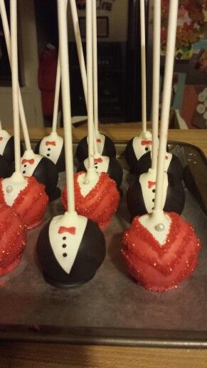 some cake pops are decorated with red and white frosting on top of each other