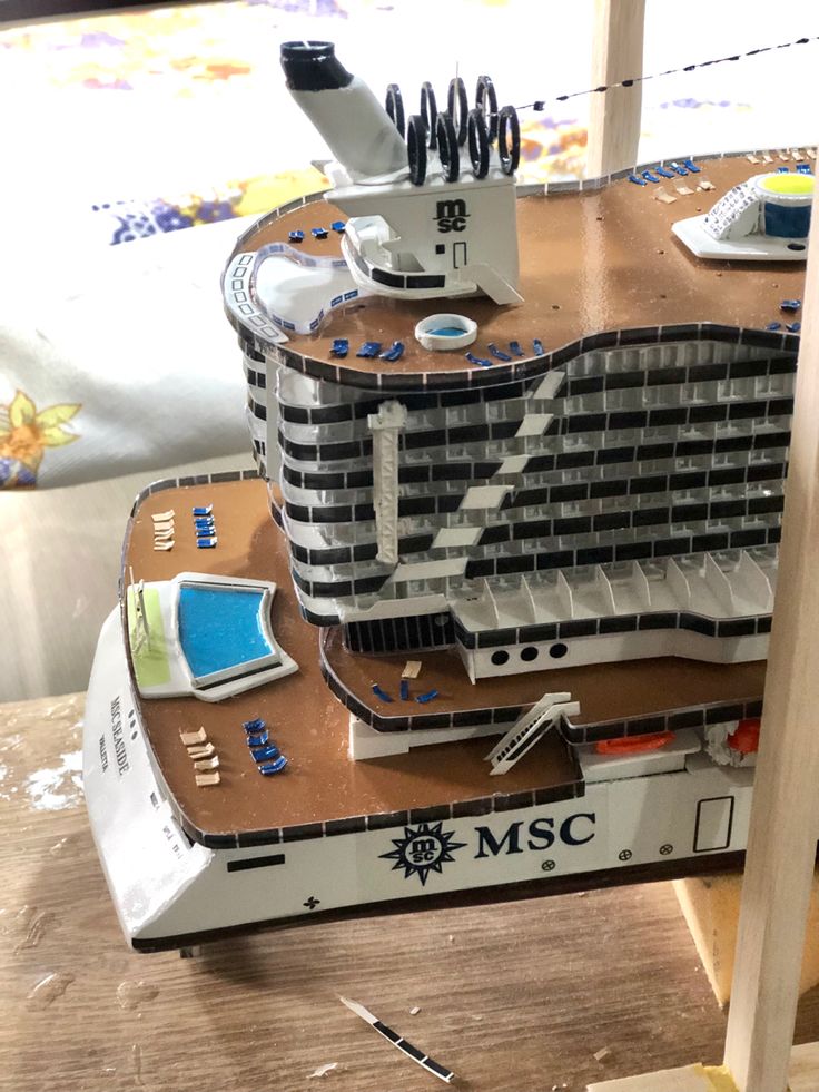 a model of a cruise ship on a wooden table