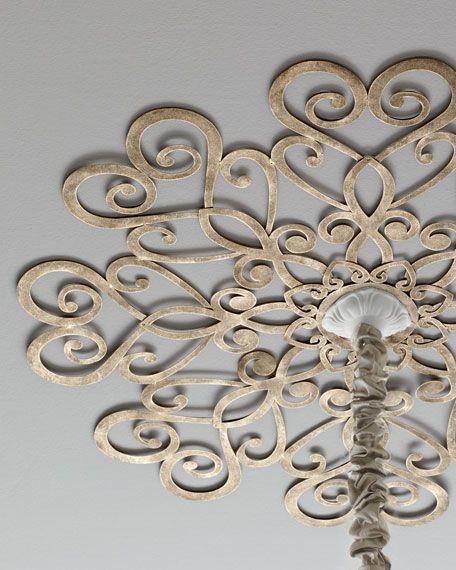 an intricately designed light fixture hangs from the ceiling