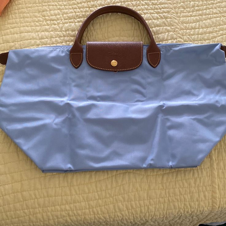 Longchamp Medium Size Packable Tote Bag (Blue Color) Brand New! Blue Bag With Snap Closure For On-the-go, Classic Light Blue Shoulder Bag For Travel, Blue Packable Travel Bag, Classic Blue Bag With Snap Closure, Classic Light Blue Travel Bag, Light Blue Travel Bags With Leather Handles, Blue Shoulder Bag With Rolled Handles For Travel, Blue Travel Bags With Rolled Handles, Blue Foldable Tote Bag