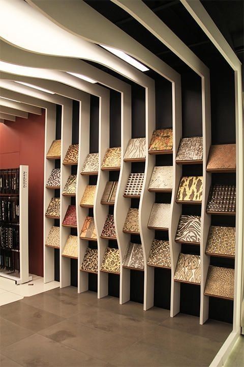 a room filled with lots of different types of rugs and floor coverings on shelves