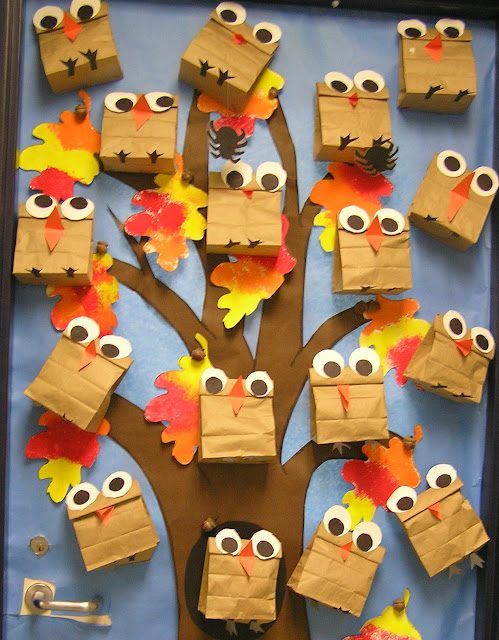 a tree made out of paper bags with owls and leaves on it's branches