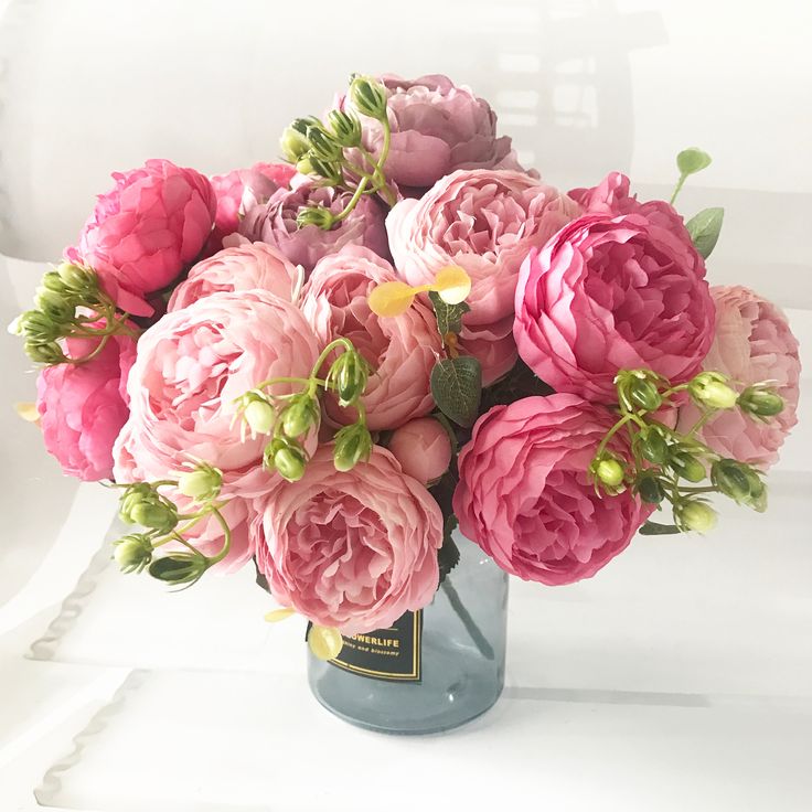 a vase filled with pink flowers on top of a table