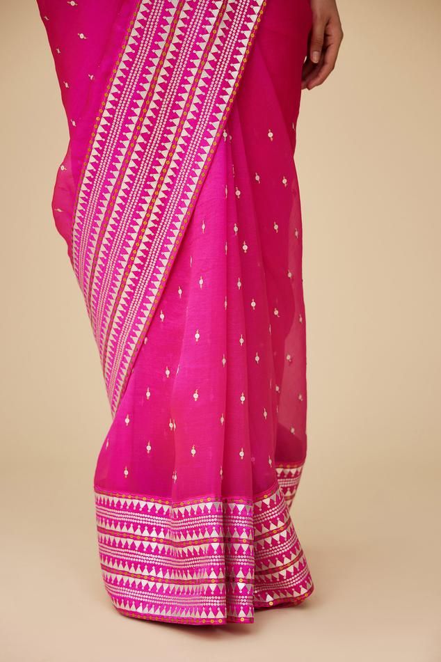 Fuchsia pink saree in silk organza base with all over prism pattern aari embroidery with sequins and zari. Paired with halter neck sleeveless blouse and a petticoat.
Components: 3
Pattern: Embroidery
Type Of Work: Aari Work With Sequins and Zari
Neckline: Halter Neck
Sleeve Type: Sleeveless
Fabric: Saree: Silk Organza, Blouse: Poly Satin, Petticoat: Poly Satin
Color: Pink
Other Details: 
Length:
Saree: 5.6-5.75inches
Petticoat: 39inches
Occasion: Wedding, Puja - Aza Fashions Festive Pink Silk Pre-draped Saree, Festive Pink Pre-draped Saree With Motifs, Pink Chanderi Pre-draped Saree With Cutdana, Pink Slub Silk Pre-draped Saree With Dupatta, Transitional Pink Banarasi Silk Pre-draped Saree, Pink Pre-draped Saree With Resham Embroidery For Festivals, Transitional Season Pink Banarasi Silk Pre-draped Saree, Pink Art Silk Pre-draped Saree For Transitional Season, Pink Tussar Silk Blouse Piece For Eid