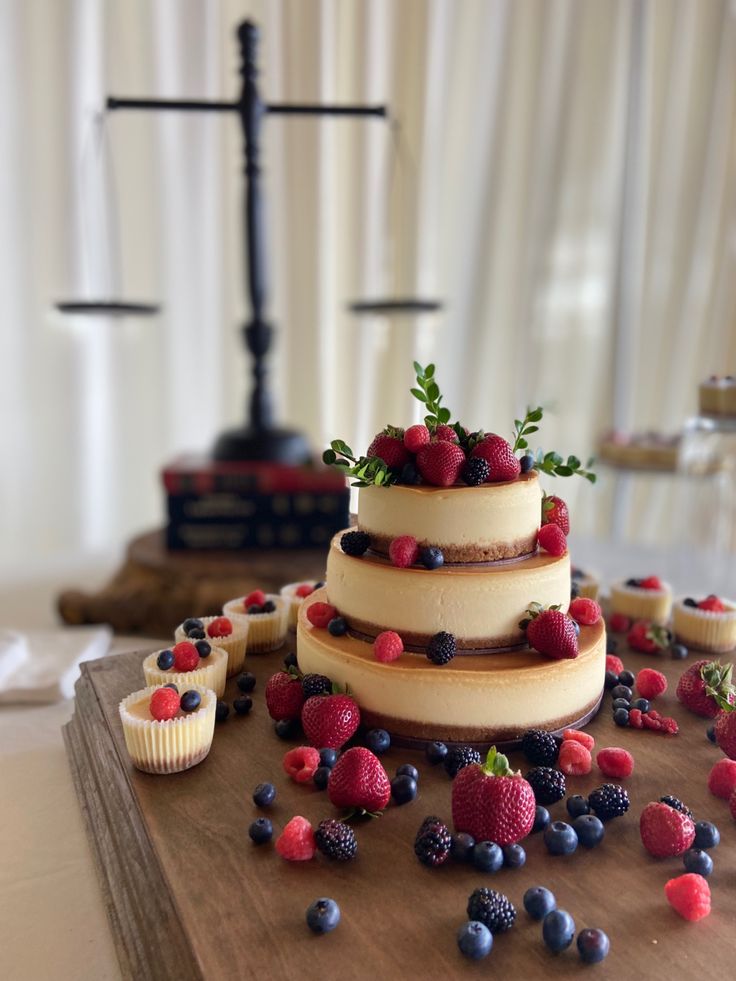 a wedding cake with berries and blueberries on it