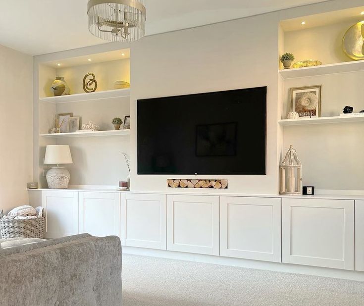 a large flat screen tv mounted to the side of a wall in a living room