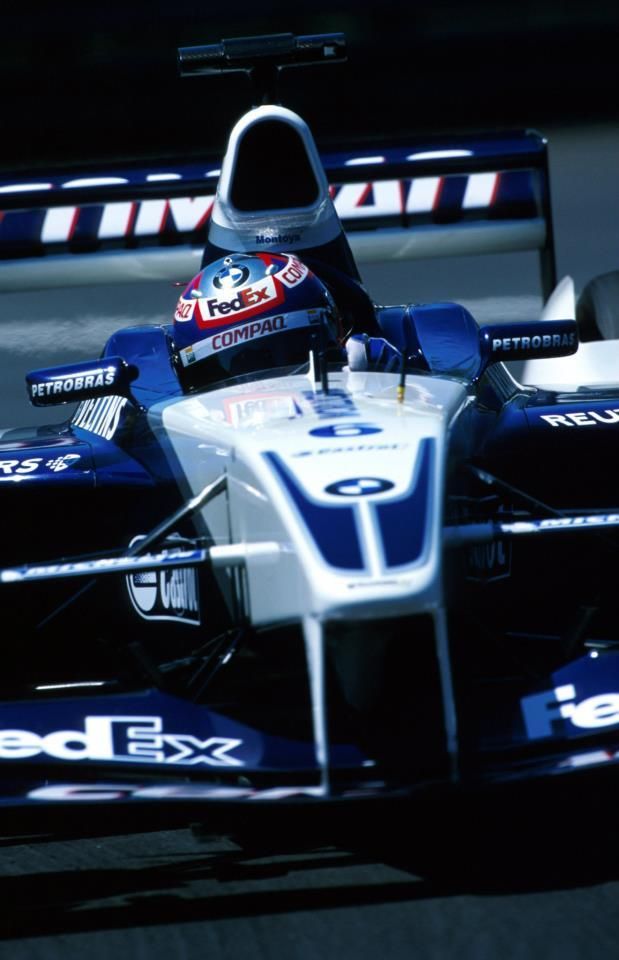 a man driving a racing car on a track