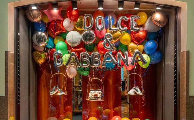 a display case filled with balloons and confetti