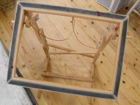 an overhead view of a wooden table with metal frame and legs on the wood floor