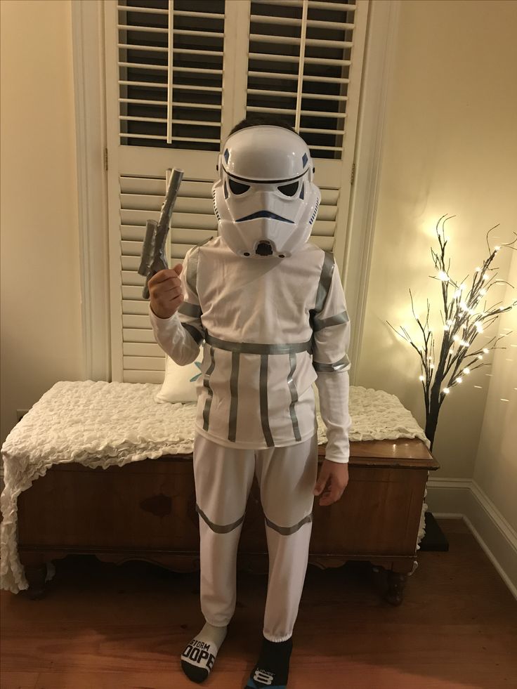 a young boy dressed as storm trooper holding a pair of scissors